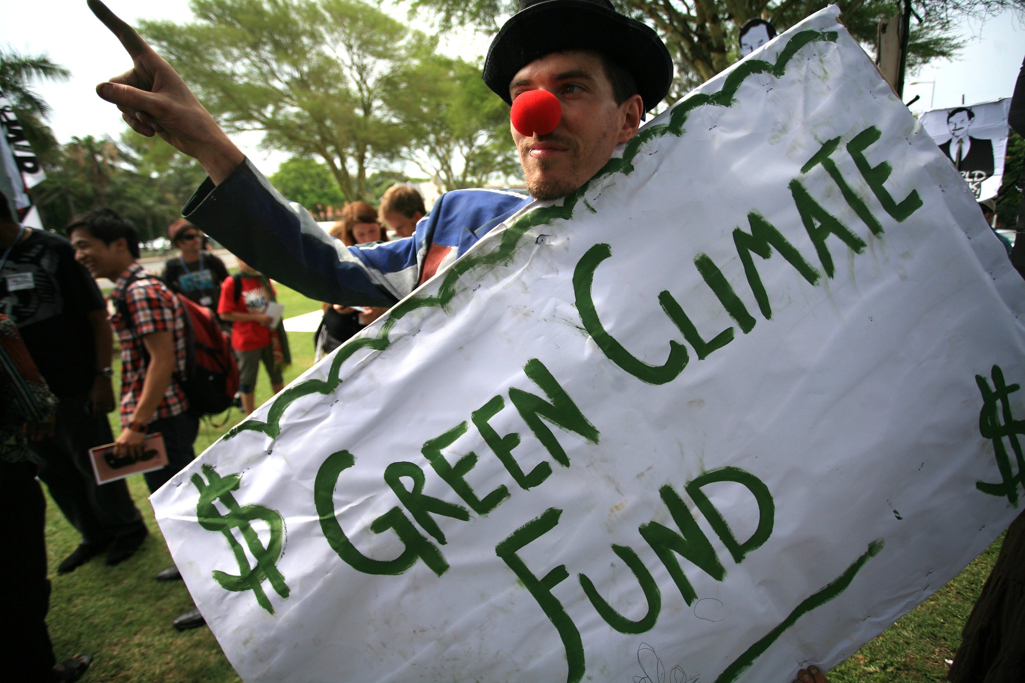 Green Climate Fund rally with man holding banner